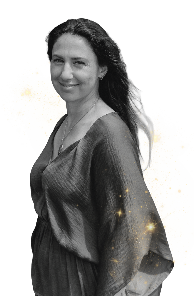 Portrait of Ivana facing away, wearing a flowing gown with gold flecks on a soft white background